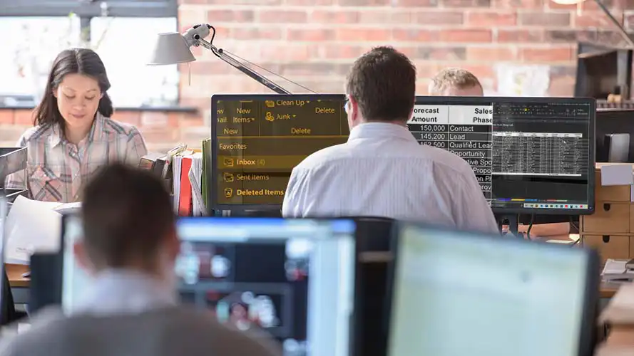 SuperNova being used on multiple screens by a man in a busy office